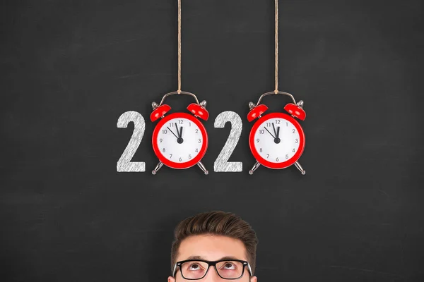 New year concepts 2020 countdown clock over human head on blackboard