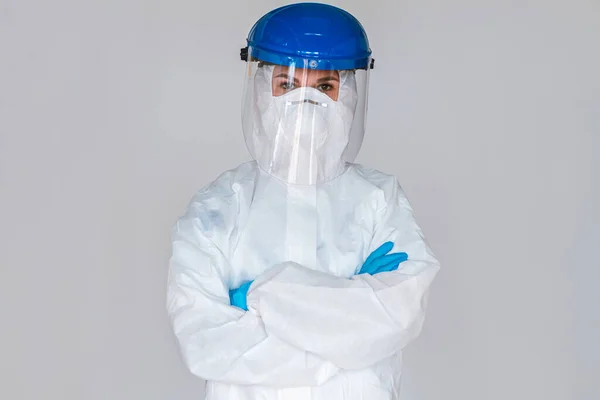 Women doctor wearing protective suit to fight coronavirus pandemic covid-2019. Protective googles, gloves, respirator.