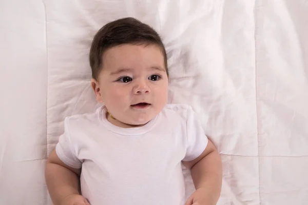 Baby Smiling Lying Bed Looking Aside — Stock Photo, Image