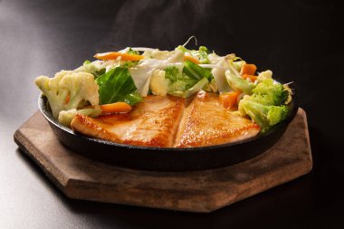 lezzetli Teppanyaki somon yemek yemek çubukları ve Demir Tavada sebze ile