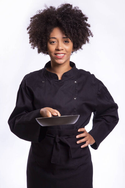 Portrait of african woman chef holding a pan isolated on white background.