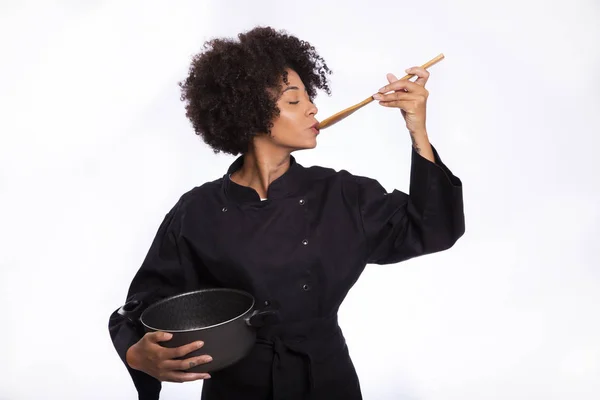 African cook woman trying food