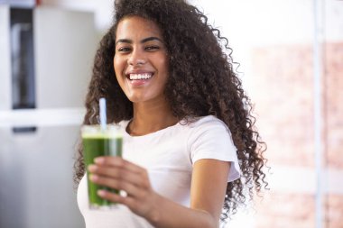 Genç Afrikalı kadın kilo kaybı ve detoks için sağlıklı vejetaryen smoothie 'den hoşlanıyor..