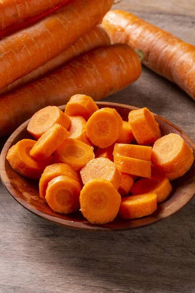 Carrots and carrot sliced on wooden table. Selective focus.