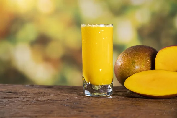 Fresh mango juice and mango fruit with a natural backdrop.