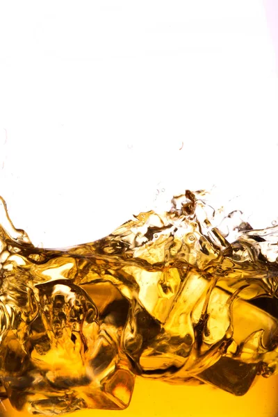 Whiskey glass with splash, isolated on white background — Stock Photo, Image