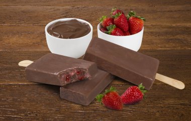 Ahşap arka plan izole çilek krema lezzet ile Stick dondurma çikolata. Meksika Paletler.