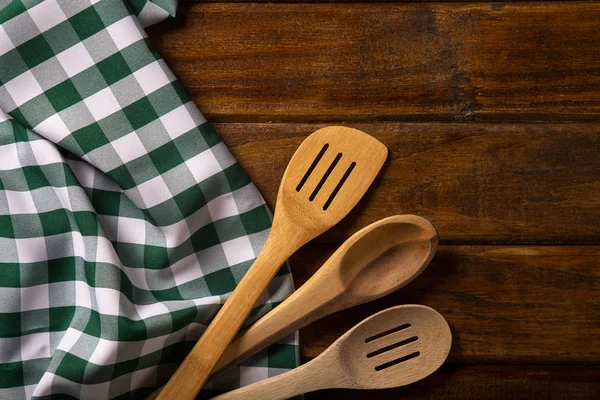 Green napkin with spoon on the table — Stock Photo, Image