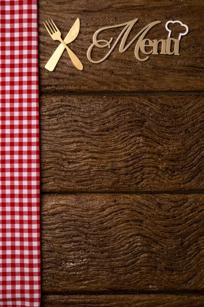 Restaurant menu. Top view of woodboard menu laying on the rustic wooden desk with accessories.