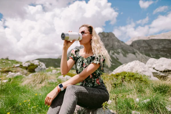 woman drinking coffee with mug and relax in mountains