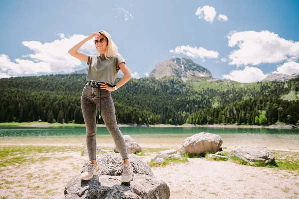 Ελκυστική γυναίκα χαλαρώστε στα βουνά με θέα στη λίμνη και το δάσος — Φωτογραφία Αρχείου