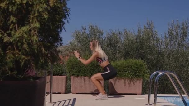 Sporty woman squats butt workout outdoors — Video