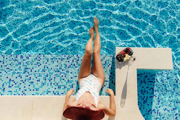 Wanita bersantai di kolam renang dan minum sampanye — Stok Foto
