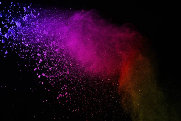 Explosion of colored powder on black background. Colorful of dust explode.