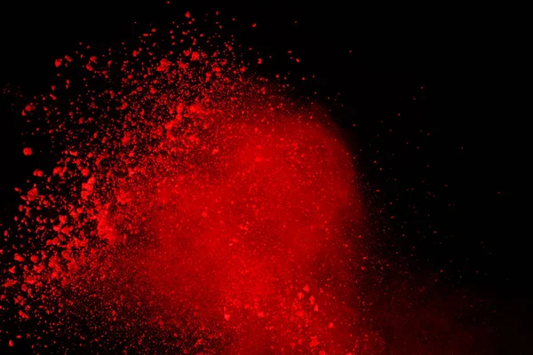 Soyut siyah zemin üzerine kırmızı toz patlaması. Kırmızı toz splatted izole et. Renkli bulut. Renkli toz patlayabilir. Boya Holi.