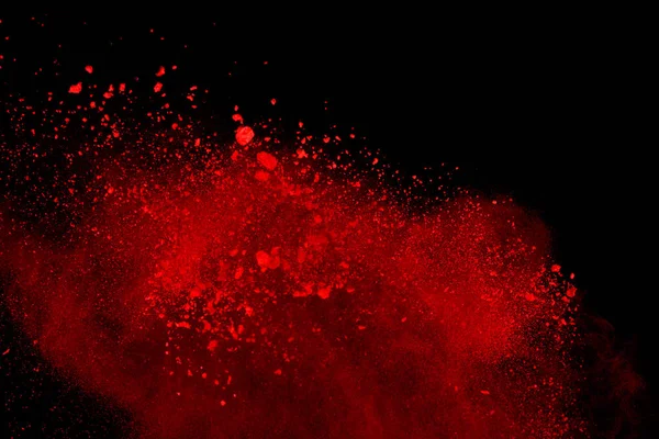 Abstract of red powder explosion on black background. Red powder splatted isolate. Colored cloud. Colored dust explode. Paint Holi.