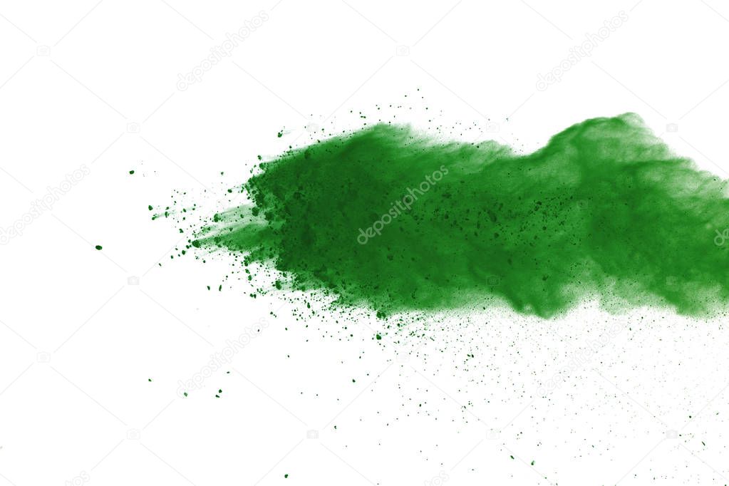 Freeze motion of Green powder exploding on white background.