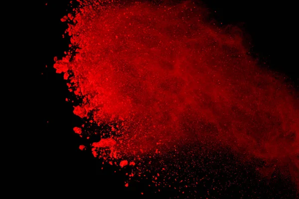 Abstract of red powder explosion on black background. Red powder splatted isolate. Colored cloud. Colored dust explode. Paint Holi.