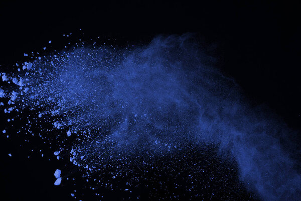 Blue powder explosion on black background. Colored cloud. Color dust explode. Paint Holi.