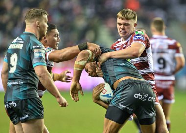Esan Marsters of Huddersfield Giants is tackled by Harvie Hill of Wigan Warriors, during the Betfred Super League Round 3 match Wigan Warriors vs Huddersfield Giants at DW Stadium, Wigan, United Kingdom, 1st March 202 clipart