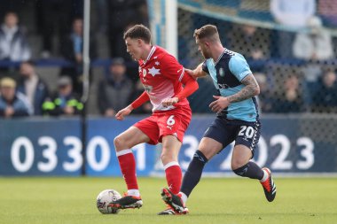 Mal de Gevigney of Barnsley and Dale Taylor of Wycombe Wanderers battle for the ball during the Sky Bet League 1 match Wycombe Wanderers vs Barnsley at Adams Park, High Wycombe, United Kingdom, 2nd March 2024
