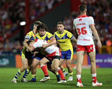 Max Wood of Warrington Wolves and Ewan Irwin of Warrington Wolves tackle Arthur Morgue of Hull KR during the Betfred Super League round 27 match Hull KR vs Warrington Wolves at Sewell Group Craven Park, Kingston upon Hull, United Kingdom 