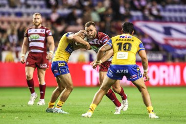 Kaide Ellis of Wigan Warriors is tackled during the Betfred Super League round 27 match Wigan Warriors vs Leeds Rhinos at The Brick Community Stadium, Wigan, United Kingdom, 19th September 2025