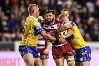 Abbas Miski of Wigan Warriors is tackled by James McDonnell of Leeds Rhinos during the Betfred Super League round 27 match Wigan Warriors vs Leeds Rhinos at The Brick Community Stadium, Wigan, United Kingdom, 19th September 2025 