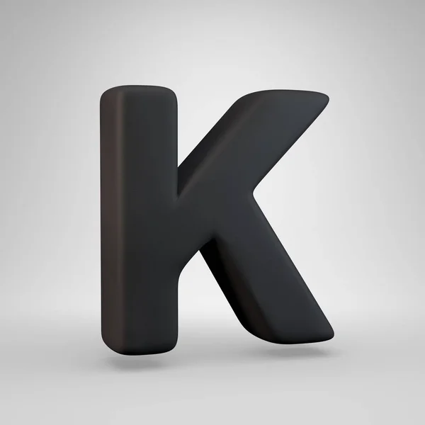 Velké černé gumové písmeno K izolované na bílém pozadí. — Stock fotografie