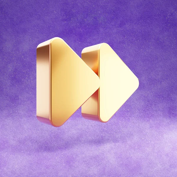 Fast forward icon. Gold glossy Fast forward symbol isolated on violet velvet background.