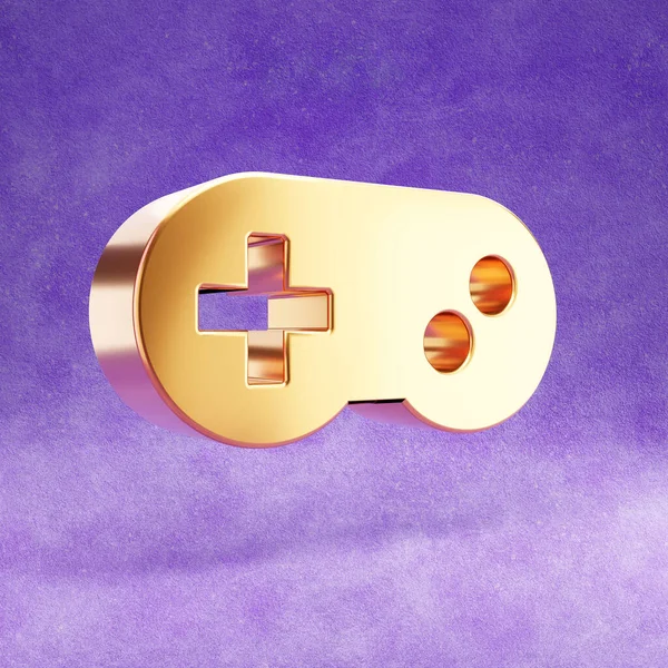 Піктограма Gamepad. Золотий глянсовий джойстик ізольований на фіолетовому оксамитовому фоні . — стокове фото