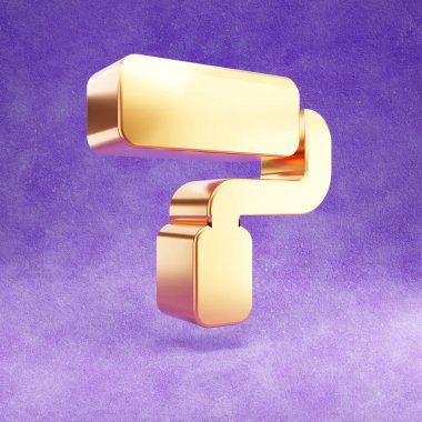 Boya silindiri ikonu. Mor kadife arka planda izole edilmiş altın renkli boya silindiri sembolü.