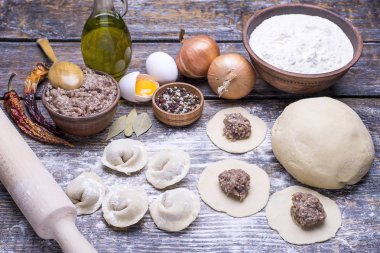 Hamur köfteleri ve kıyma, un, hamur, kıyma, kıyma, yumurta, zeytinyağı, baharatlar, tuz, biber, ahşap bir tahtada defne yaprağı, arka plan.