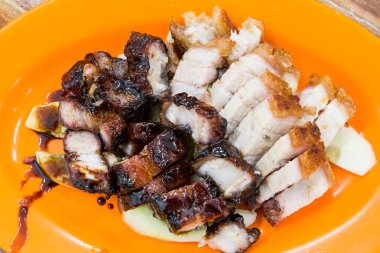 Simple serving of delicious Chinese style roast pork or siew yuk and char siew clipart