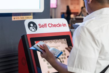 Kuala Lumpur, Malezya, 18 Haziran 2018: onların uçuş kontrol etmek için Kl Uluslararası Havaalanı tesisinde iade uygun öz kiosk makine kullanarak yolcu.