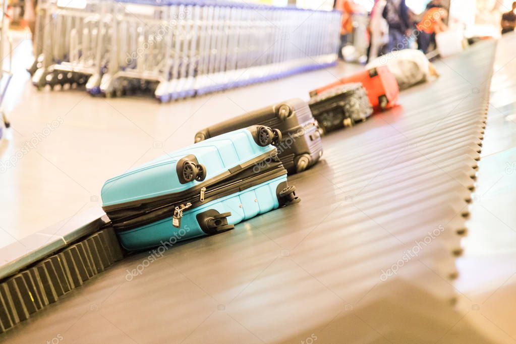 Closeup of luggage bag on airport conveyor belt for pickup