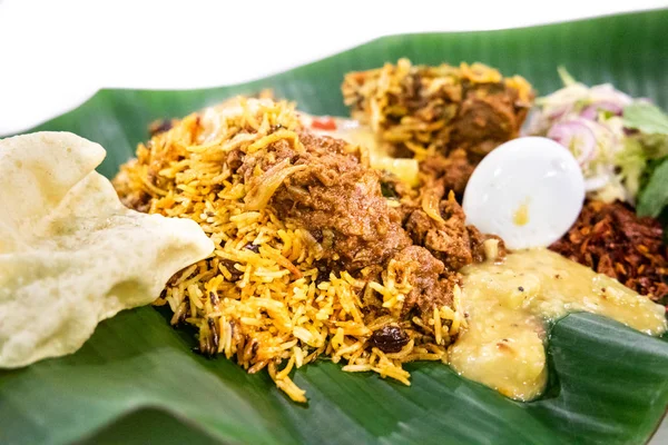 Delicious nasi briyani with lamb mutton served on banana leaf plate, popular food in Malaysia