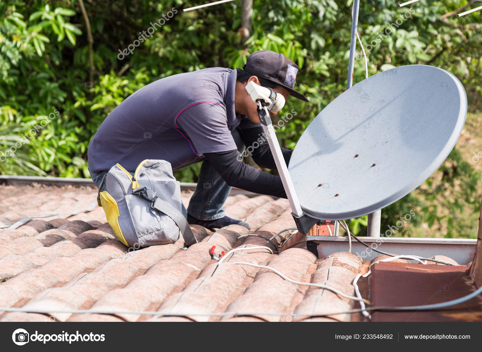 Skillful Technician Worker Installing Satellite Dish Television Antenna