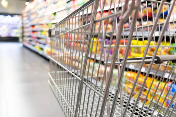 Einkaufswagen Vor Modernem Supermarkt Gang Verschwimmt Hintergrund — Stockfoto