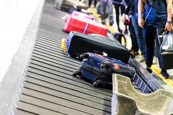 Baggage luggage on conveyor carousel belt at airport arrival for reclaim