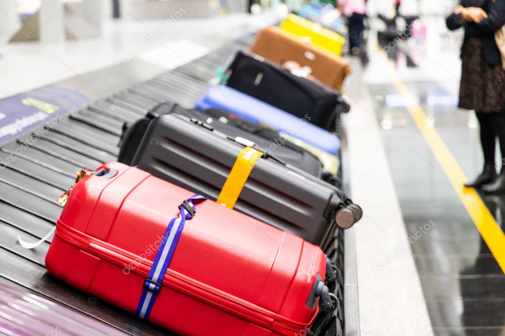 Baggage luggage on conveyor carousel belt at airport arrival for reclaim