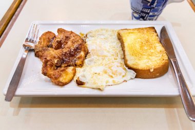 Basit hiçbir fırfırlar domuz pirzolası, kızarmış yumurta, tost ekmeği çay, Hong Kong'da kahvaltı seti ile