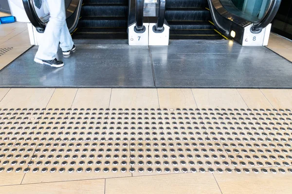 Metal floor tactile to guide vision impaired person at shopping mall in Hong Kong