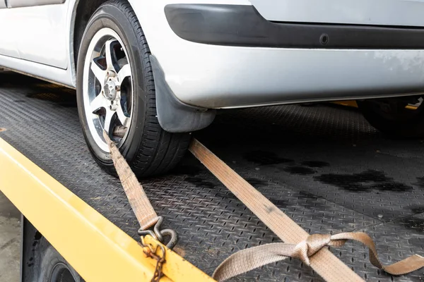 Car tied with security strap on flatbed tow truck — Stock Photo, Image