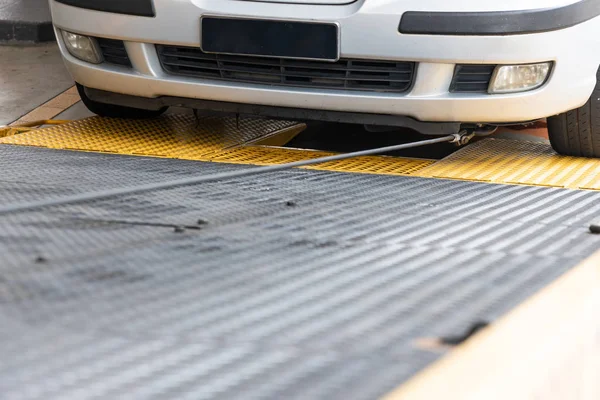 Closeup on car towed onto flatbed tow truck with cable — Stock Photo, Image
