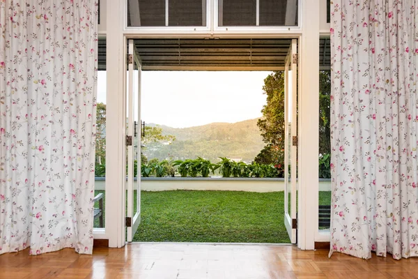 Glass door opening to refreshing, green, nature landscape scenic