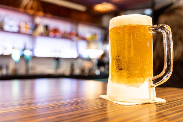 Kufel bardzo zimnego i orzeźwiającego piwa z tłem pubu — Zdjęcie stockowe