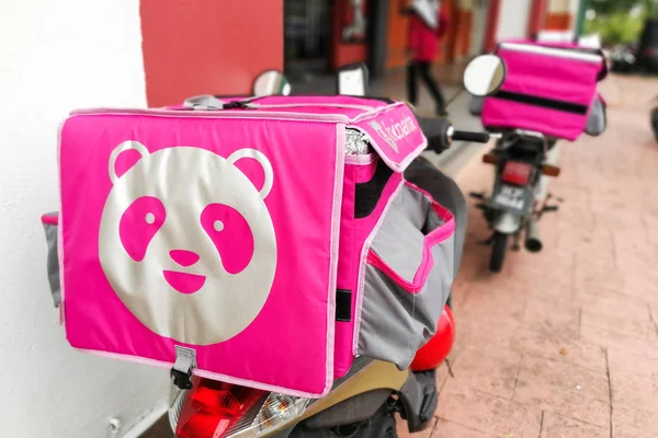 KUALA LUMPUR, MALAYSIA, September 17, 2019: Foodpanda riders waiting outside restaurants for food delivery services assignment.    Foodpanda is a up and coming food delivery service provider in Malaysia.