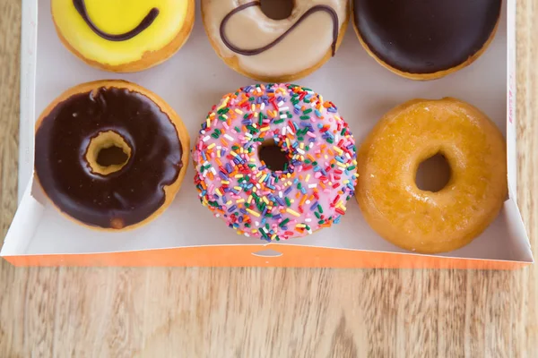 Colorful donuts in box