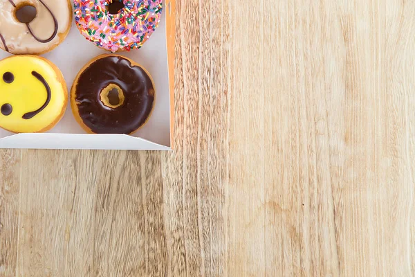 Colorful donuts in box